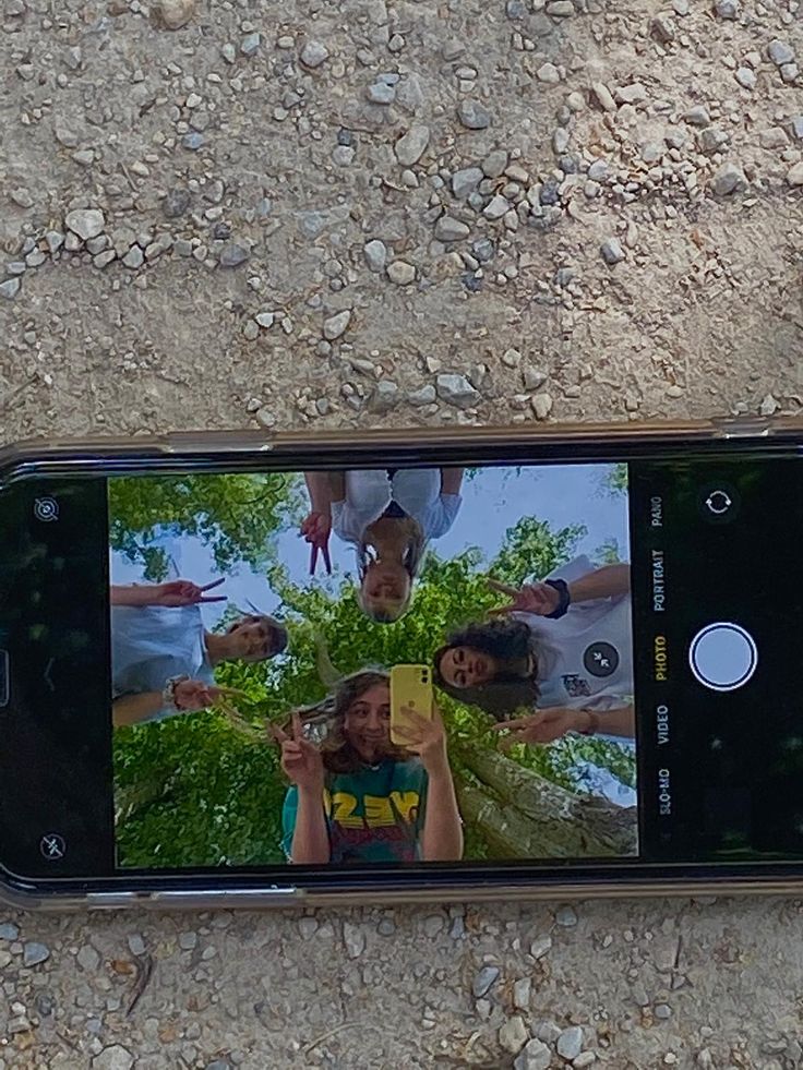 a cell phone is laying on the ground and taking a photo with it's camera