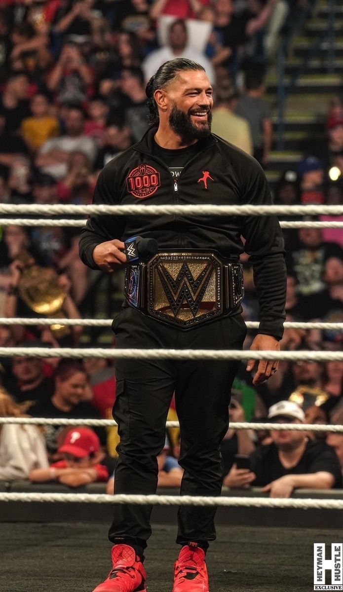 a man standing in front of a wrestling ring