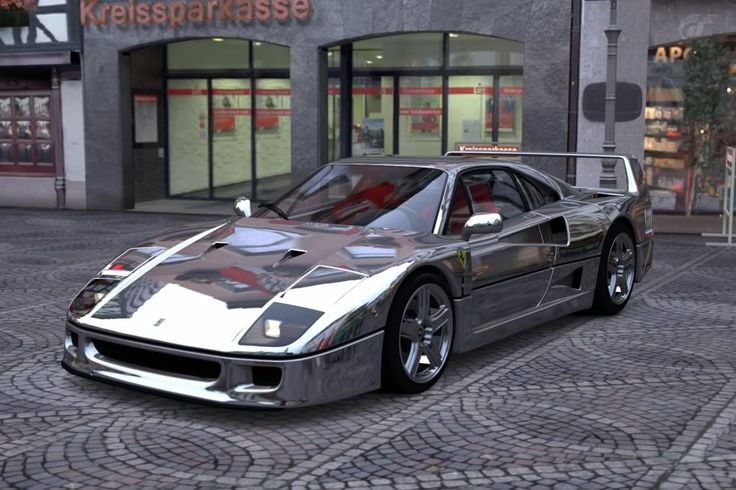 a silver sports car parked in front of a store