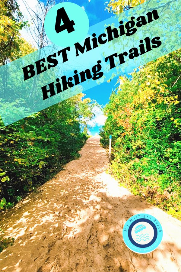 a dirt road surrounded by trees with the words best michigan hiking trails on it's side