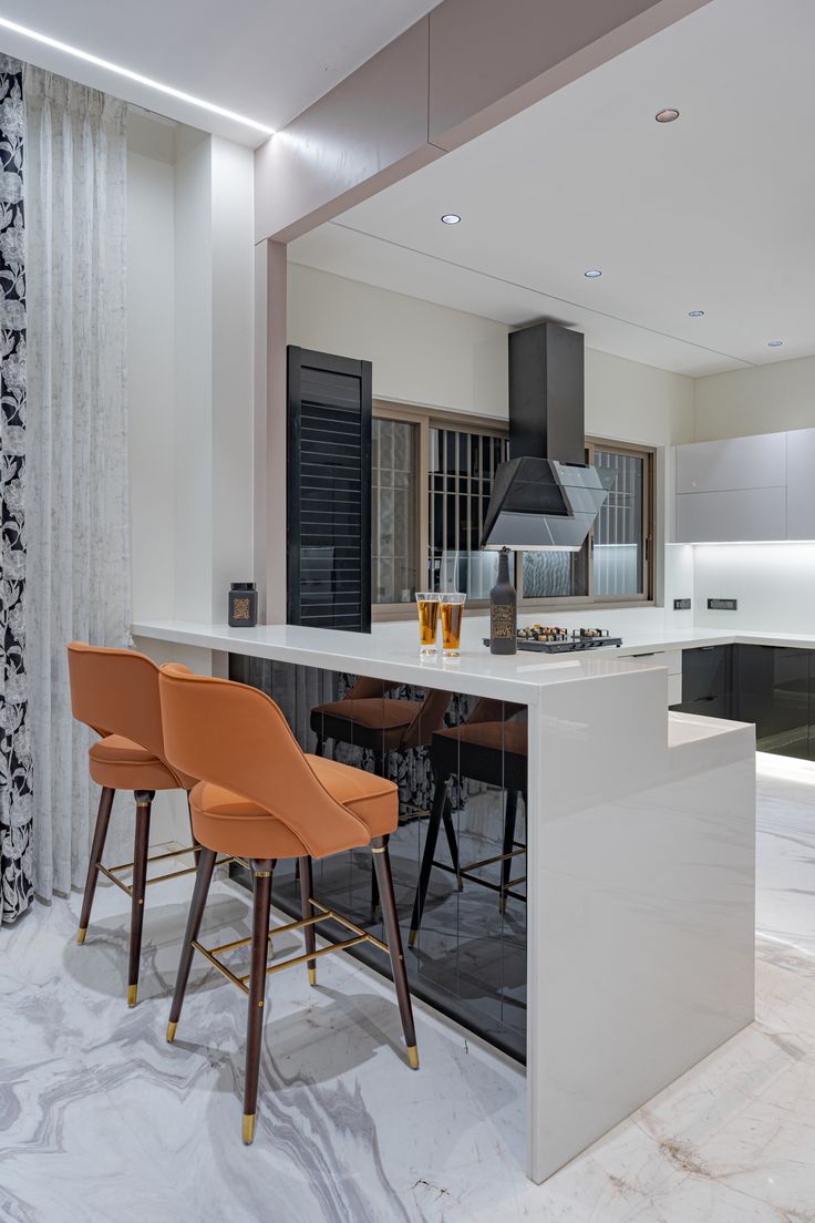 a kitchen with an island and bar stools