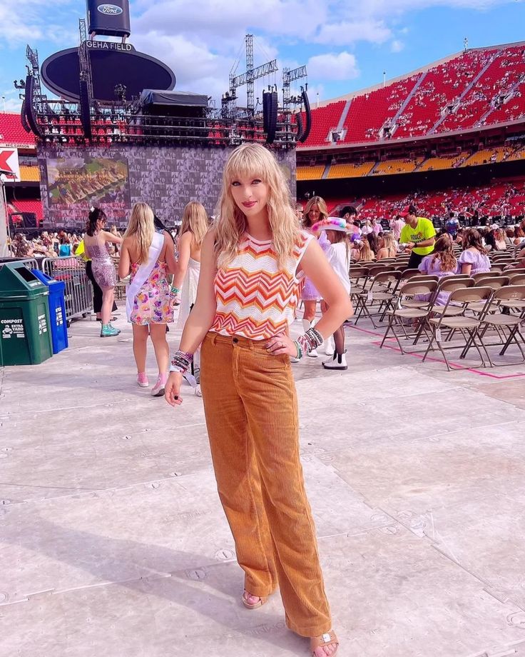 a woman standing in front of an empty stadium