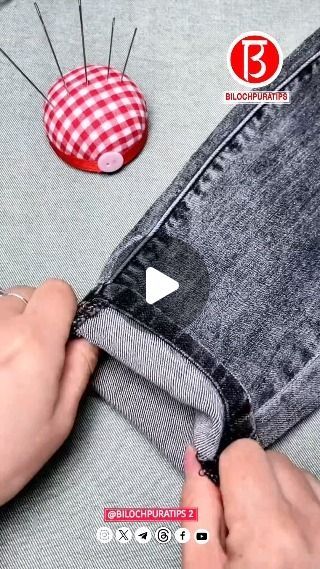 someone is making a button on the back of a pair of jean pants with buttons