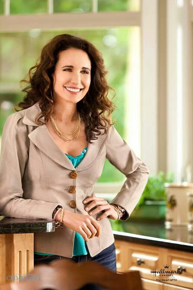 a woman standing in a kitchen next to a counter