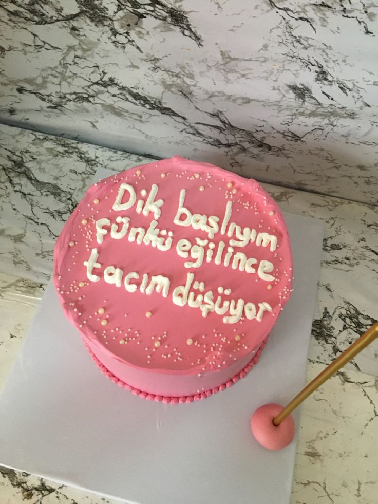 a pink cake sitting on top of a counter