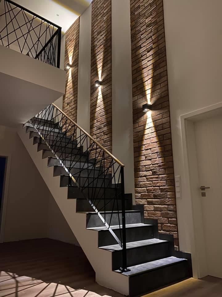 a stair case with two lights on each side