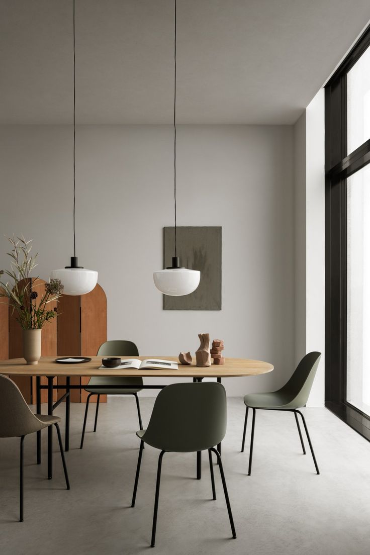 a dining room table with four chairs and a vase on the top shelf next to it