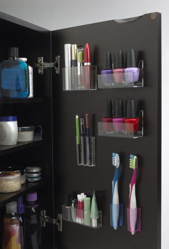 an open cabinet filled with lots of different types of toothbrushes and other items