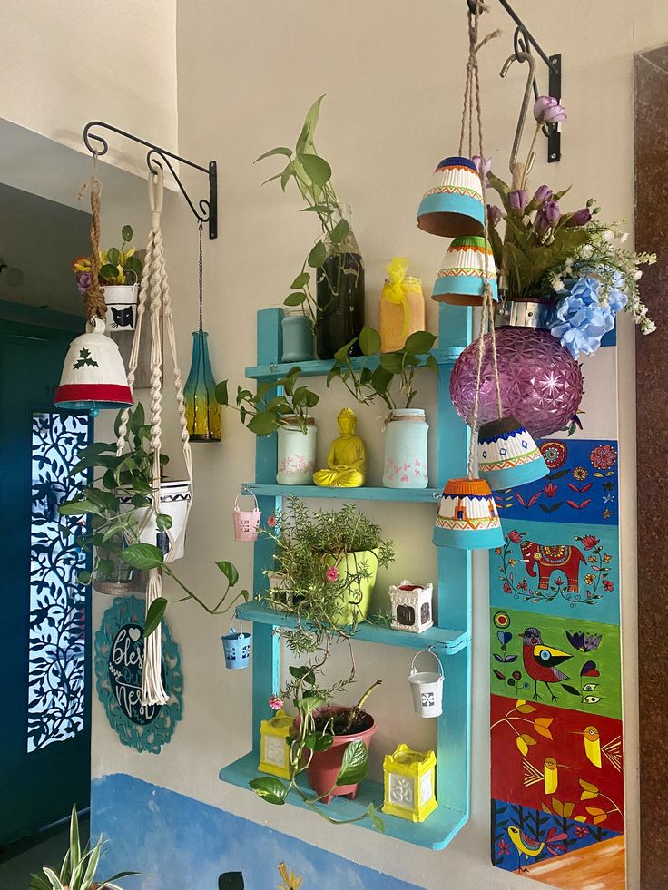 several pots and plants are hanging on the wall