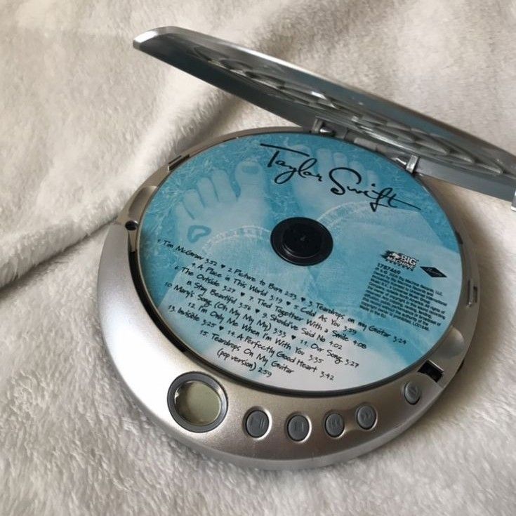 a cd that is sitting on top of a white cloth covered surface with the disc in it's case
