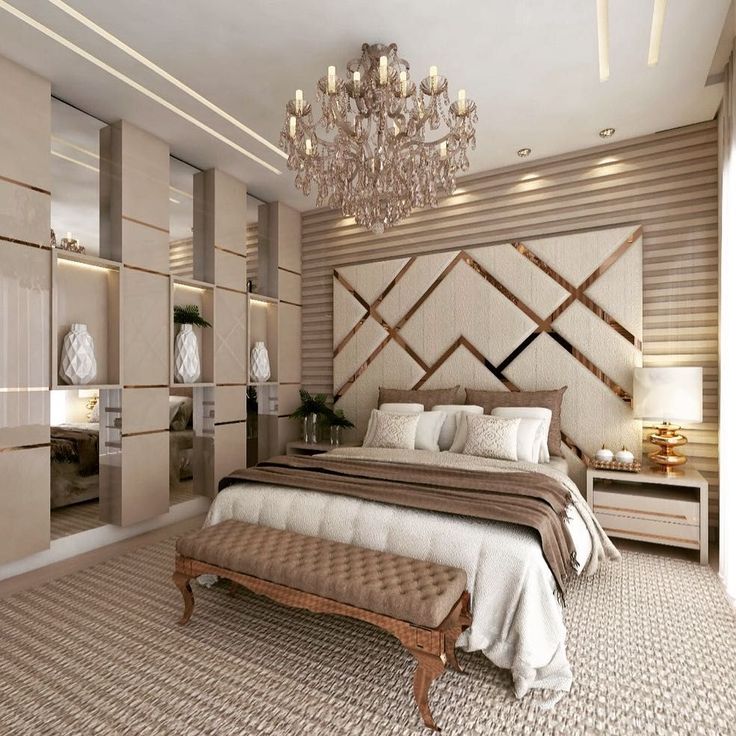 a bedroom with a large bed and chandelier