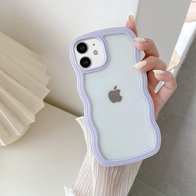 a person holding an iphone case in front of a white wall with the apple logo on it