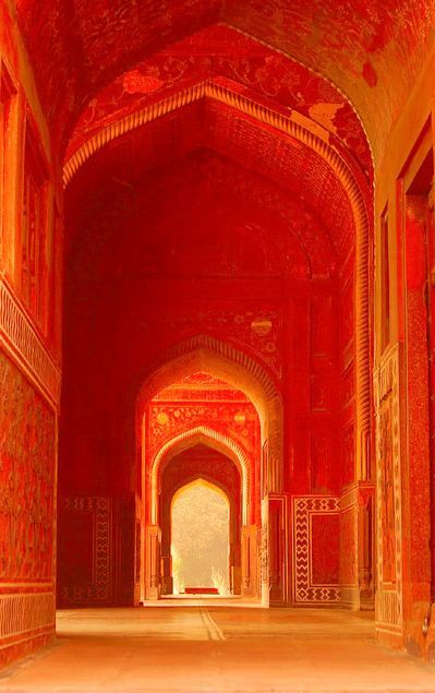 an archway in the middle of a building with intricate carvings on it's walls