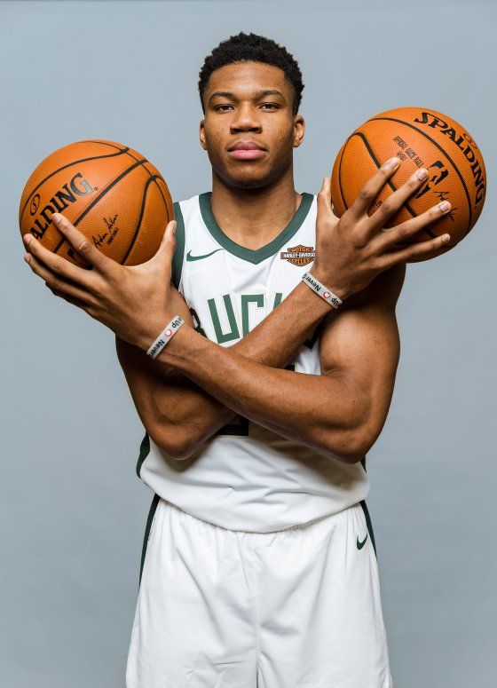 a man holding two basketballs in his hands