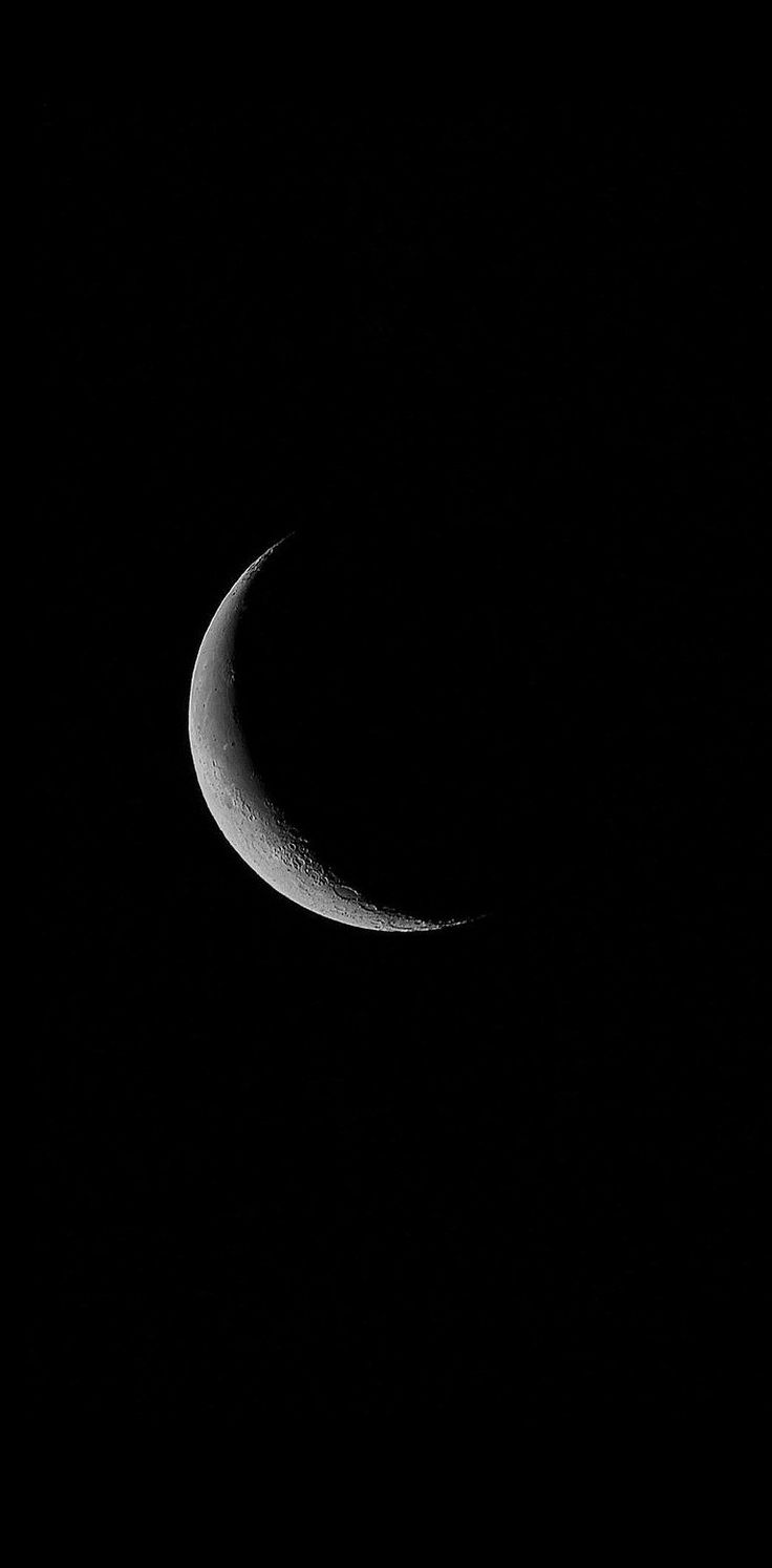 the crescent moon is seen in the dark night sky, with only one half visible