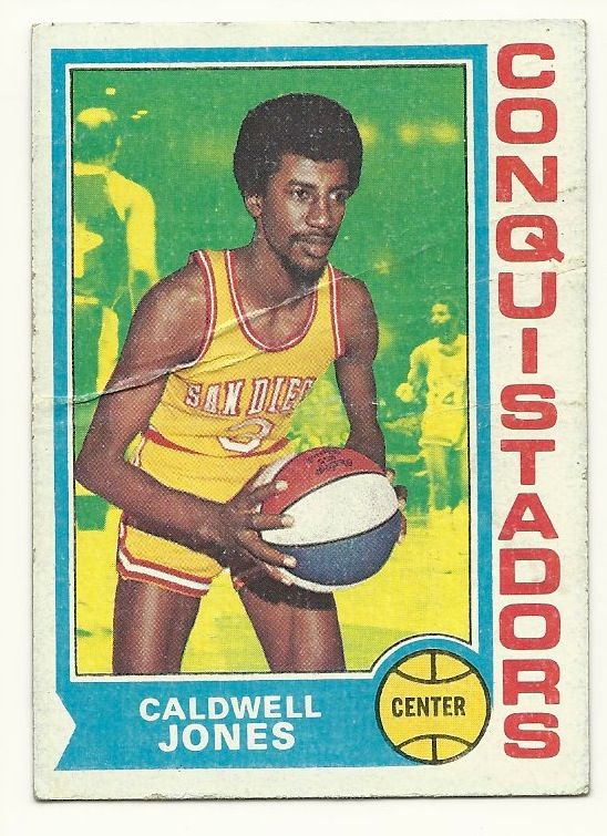 an old basketball card with a man holding a ball