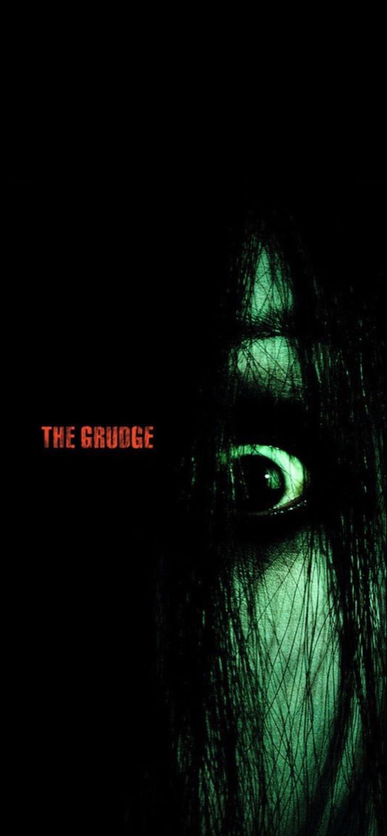 the grudge movie poster with an evil looking woman's face and green eyes