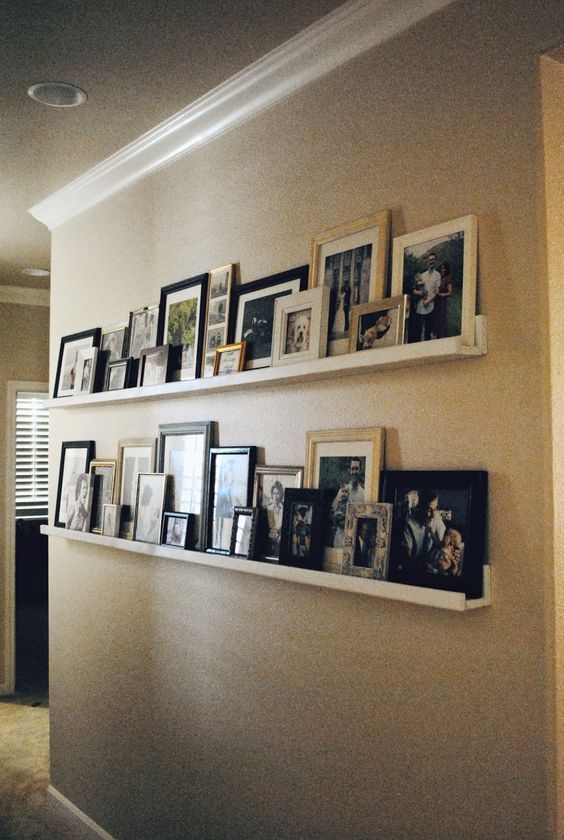 a wall filled with pictures and framed photos