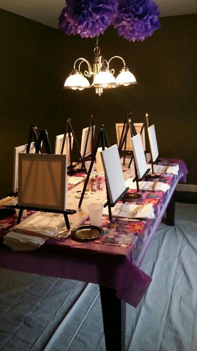 the table is set up with easels and paintings on it for an art party