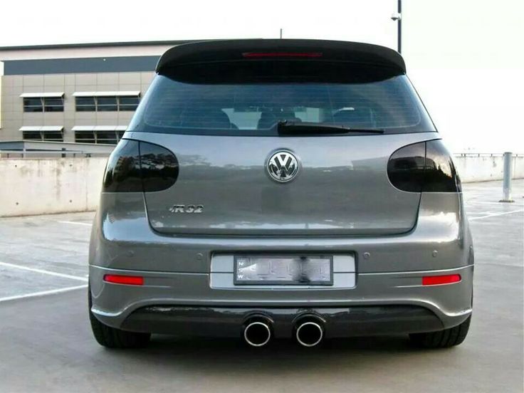 the rear end of a silver car parked in a parking lot