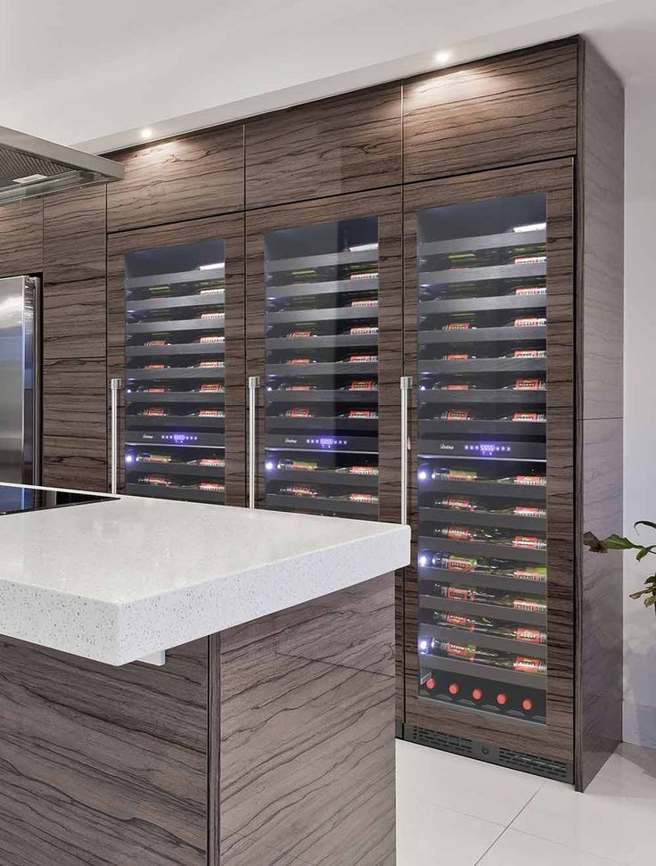 a modern kitchen with an island and wine cellar