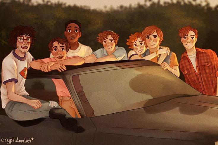 a group of people sitting on the hood of a car with their arms around each other