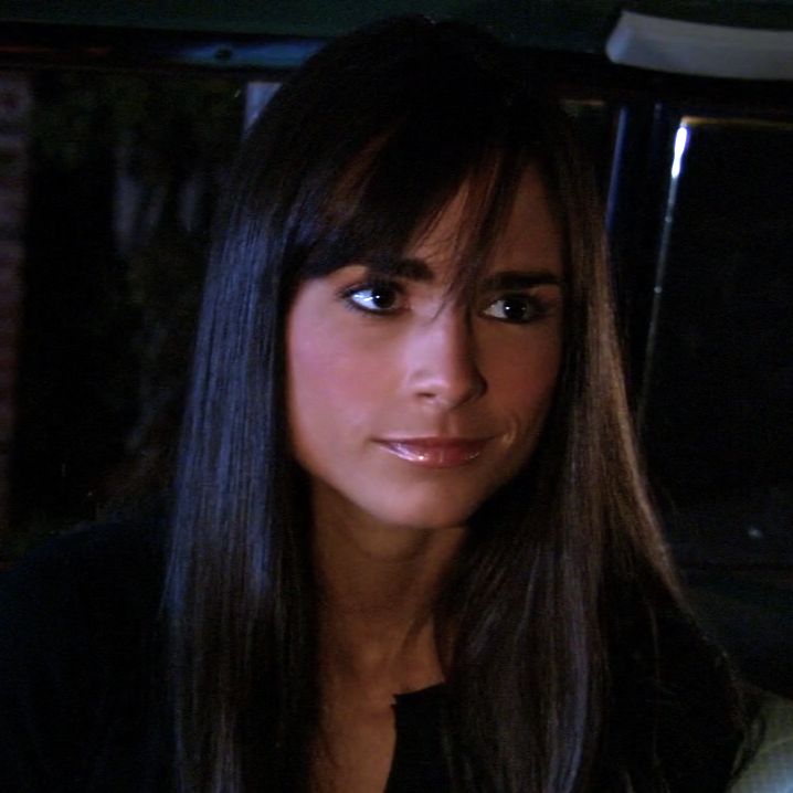 a close up of a person in a car looking at the camera with a serious look on her face