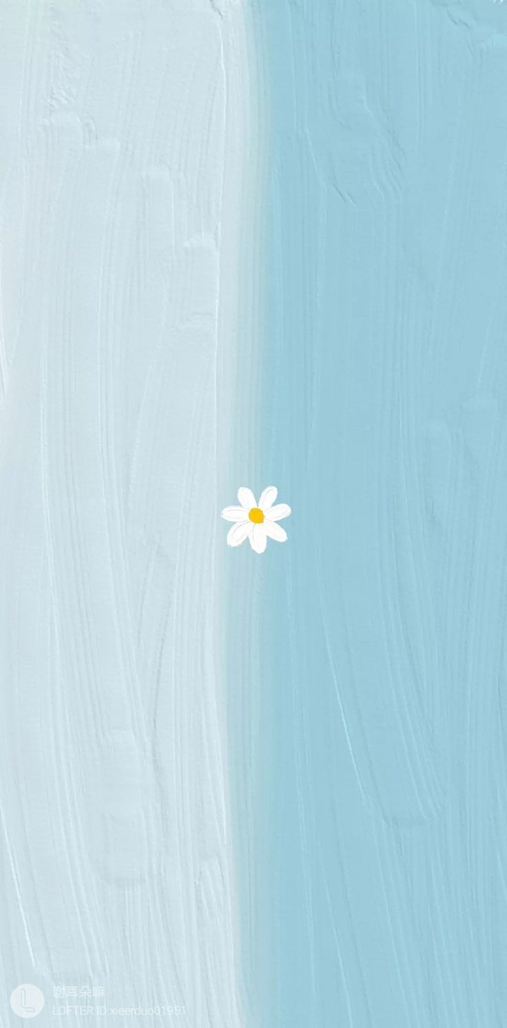a single white flower sitting on top of a blue and white wall next to the ocean