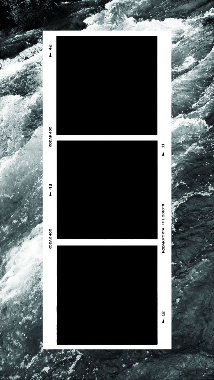 three black squares are in the middle of a body of water, with white lines on them