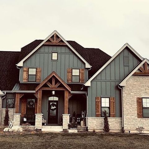 a large gray house with two story windows