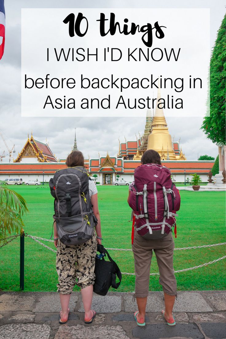 two people with backpacks looking at the grass in front of them and text overlay that reads 16 things i wish i'd know before backpacking in asia and australia