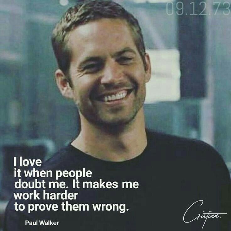 a man smiling and wearing a black shirt with a quote from paul walker on it