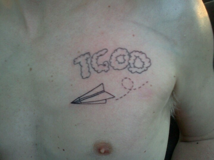 a man's chest with an airplane and the word igo written on it