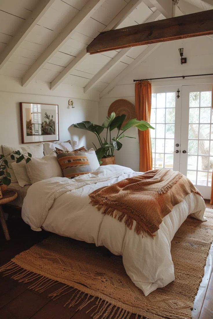 a bedroom with a bed, rug and window in the corner that has orange curtains on it