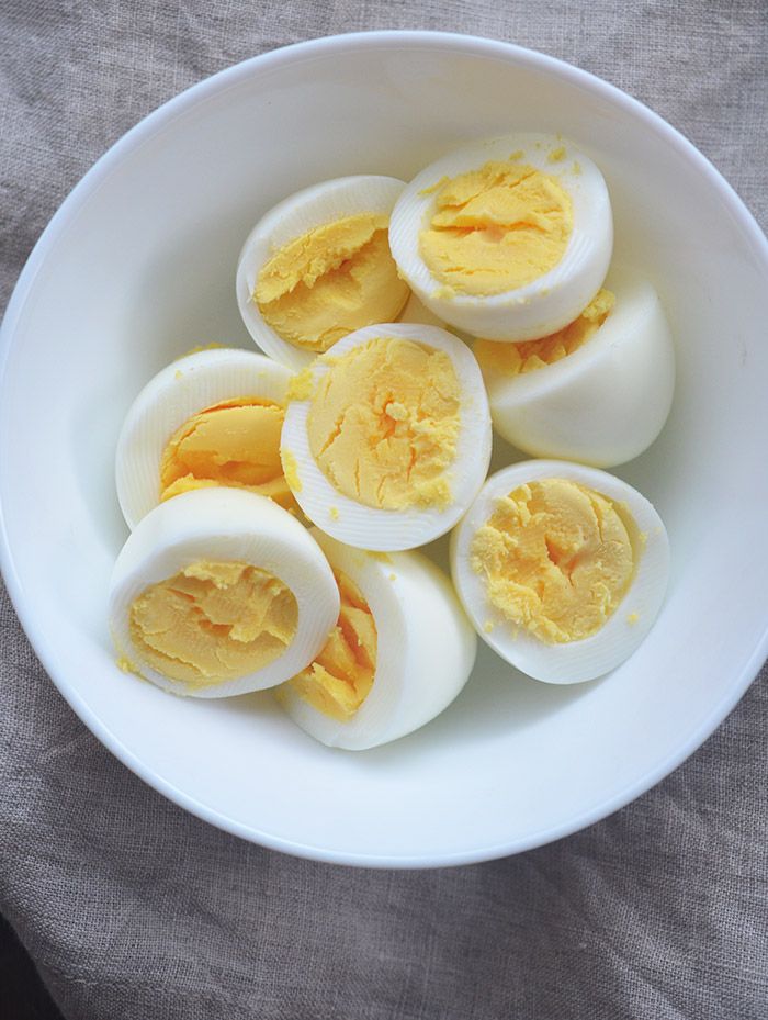 hard boiled eggs in a white bowl on a table