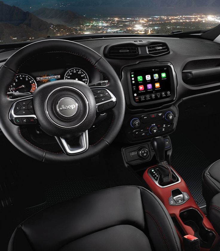 the interior of a car with dashboard, steering wheel and infotains on display