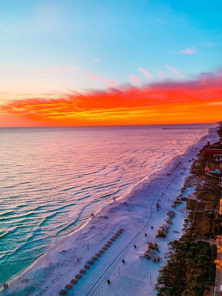 an aerial view of the beach at sunset