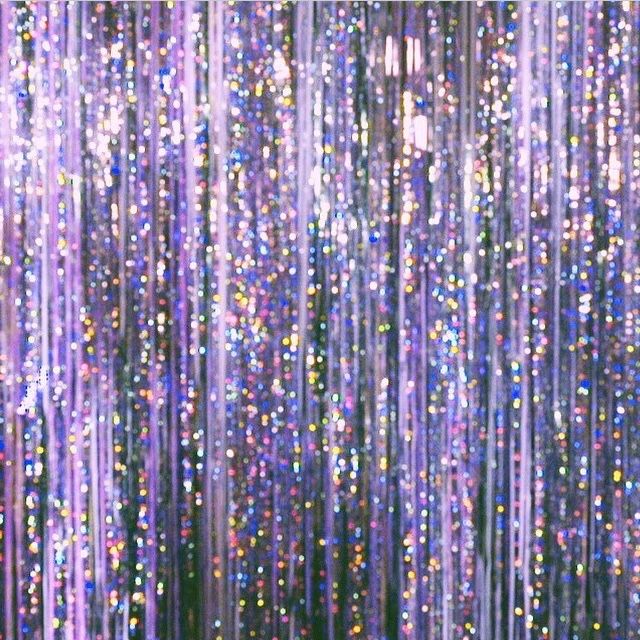 an instagram page with purple and blue glitters
