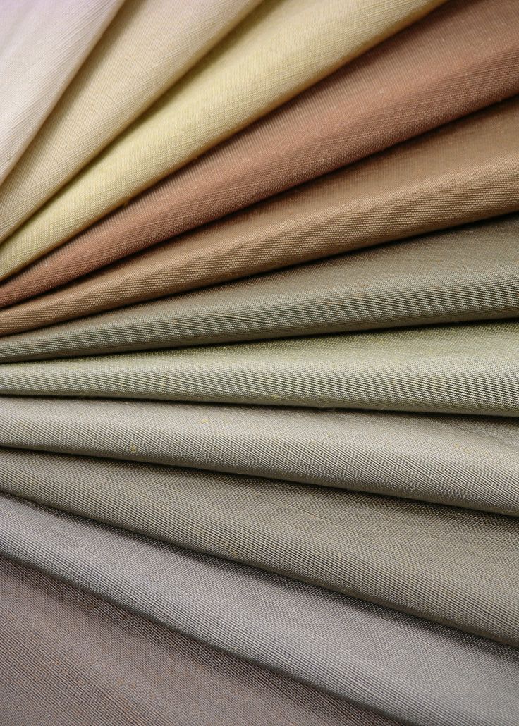 several different colors of fabric on top of each other, all in various sizes and shapes