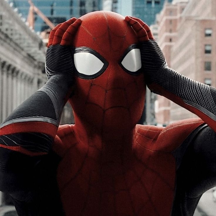 the spider - man is covering his ears with his hands