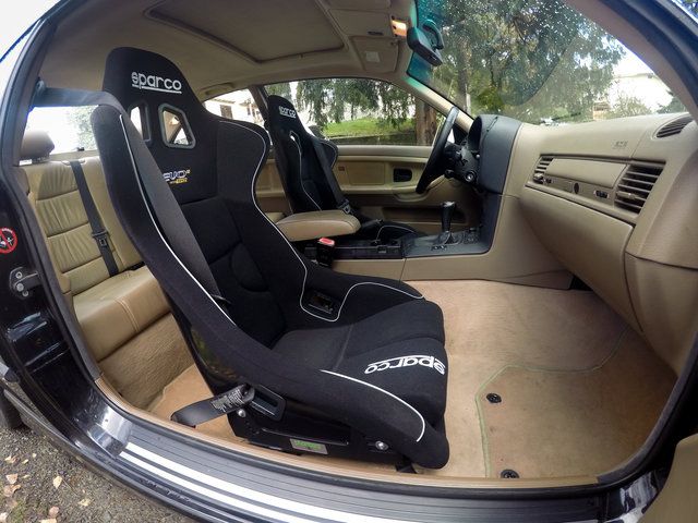 the interior of a car is shown with black and white seats in front of it