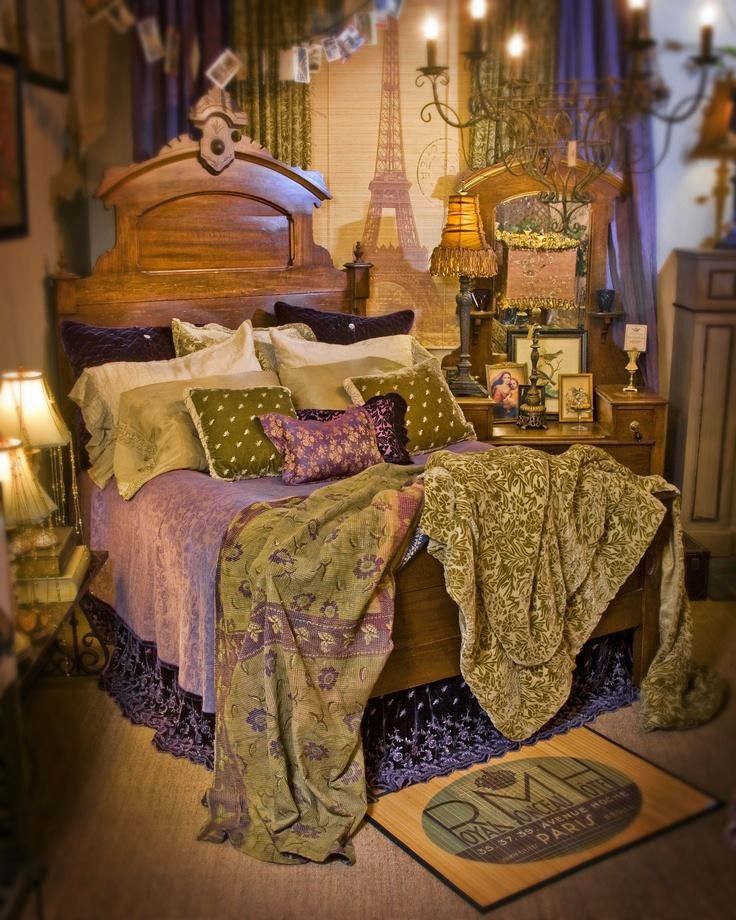 a large bed sitting inside of a bedroom next to a dresser and lamps on either side of the bed