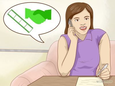 a woman sitting at a table talking on her cell phone and holding a pen to her ear