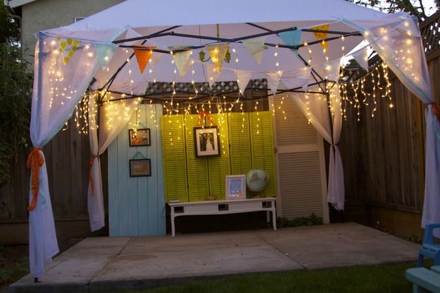 a white gazebo with lights hanging from it's sides