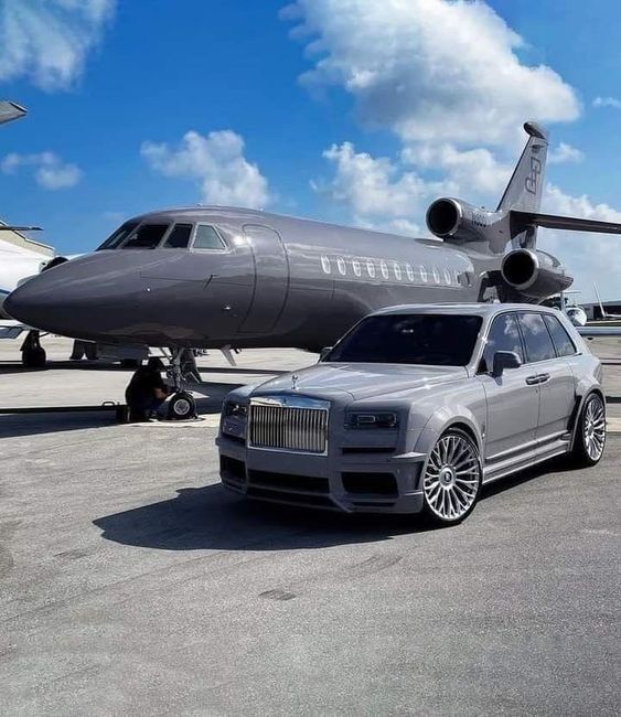 a car parked next to an airplane on the tarmac