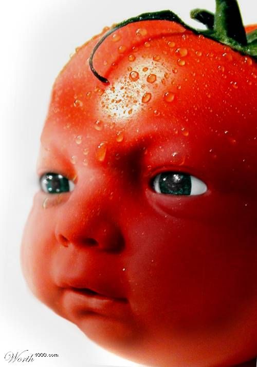 a close up of a tomato with drops of water on it's head and eyes