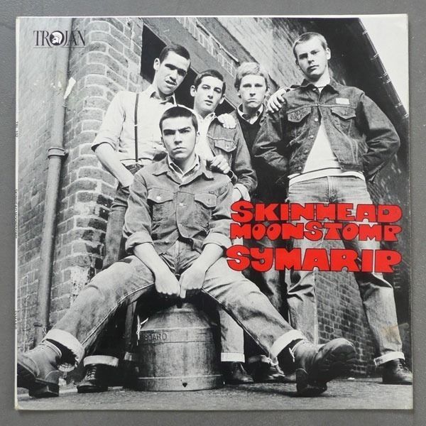 an album cover for skinhead monsstore sumarie, featuring five men sitting on a barrel