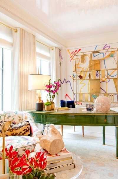 a living room filled with furniture and flowers in vases on the table next to a green coffee table