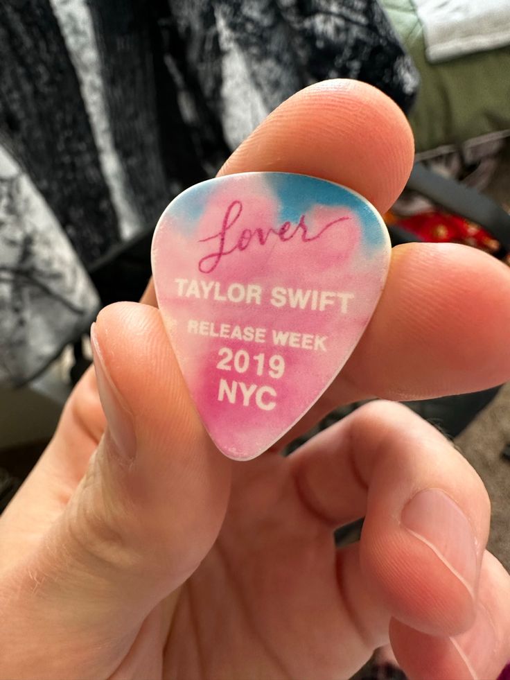 someone is holding up a guitar pick that says love taylor swift release week 2019 nyc