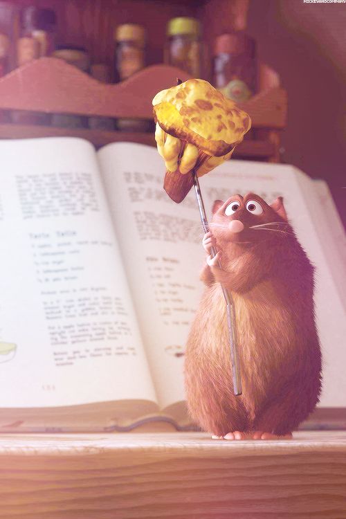 a cartoon rat holding a banana on top of an open book